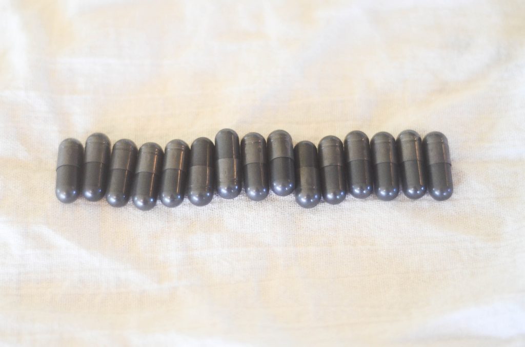 row of activated charcoal pills